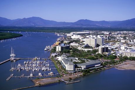 An Aerial View of a City Surrounded by Water and Mountains — Timbertop Floor Sanding & Polishing In Cairns, QLD