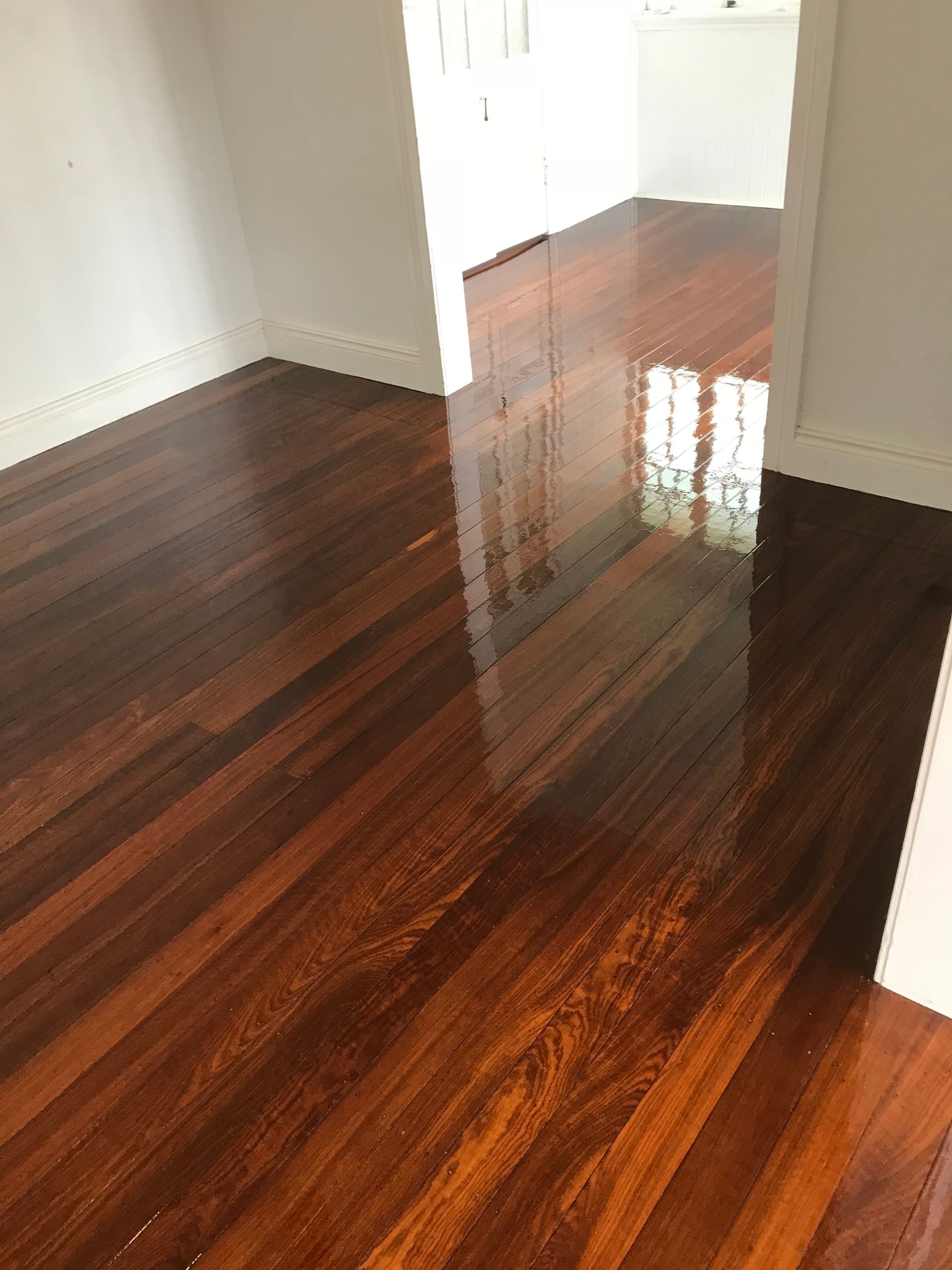 A Room With a Wooden Floor and White Walls — Timbertop Floor Sanding & Polishing In Bungalow, QLD