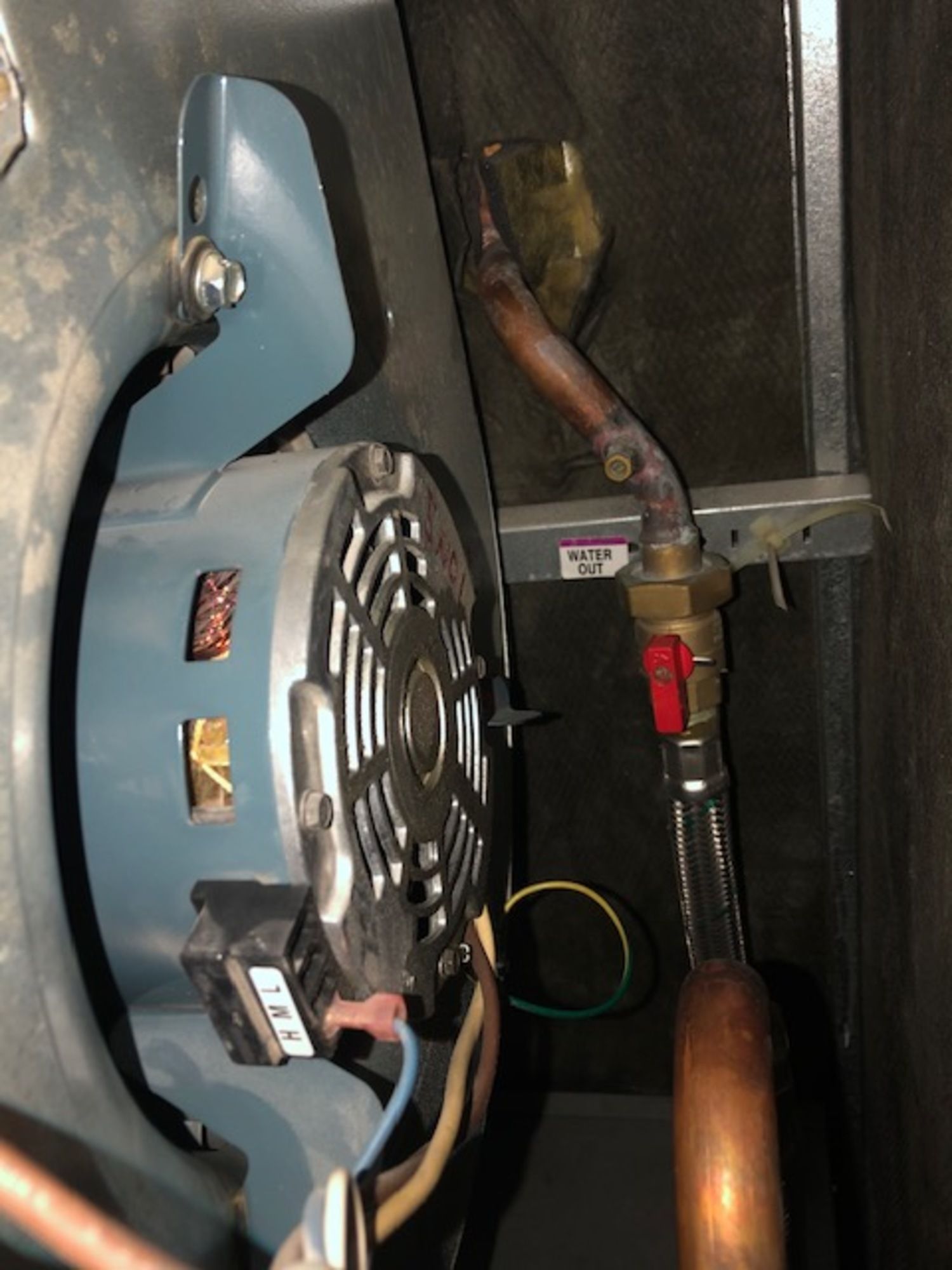 A close up of a fan with a copper pipe attached to it