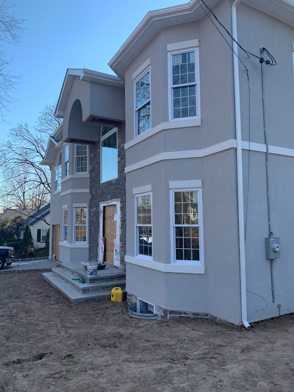 A large house with a lot of windows is being built.