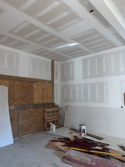 A room with a lot of pieces of wood on the floor