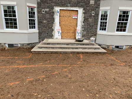 A house is being built and the front door is boarded up.