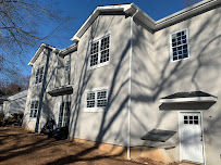 A large white house with a lot of windows and a white door.
