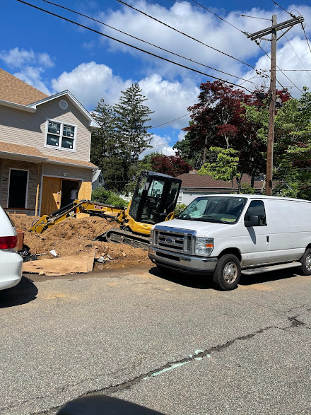 A white van is parked in front of a construction site.