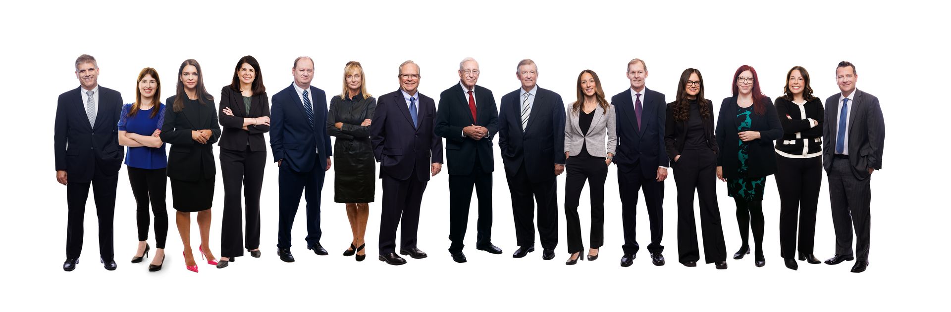 A group of people in suits and ties are standing in a line.