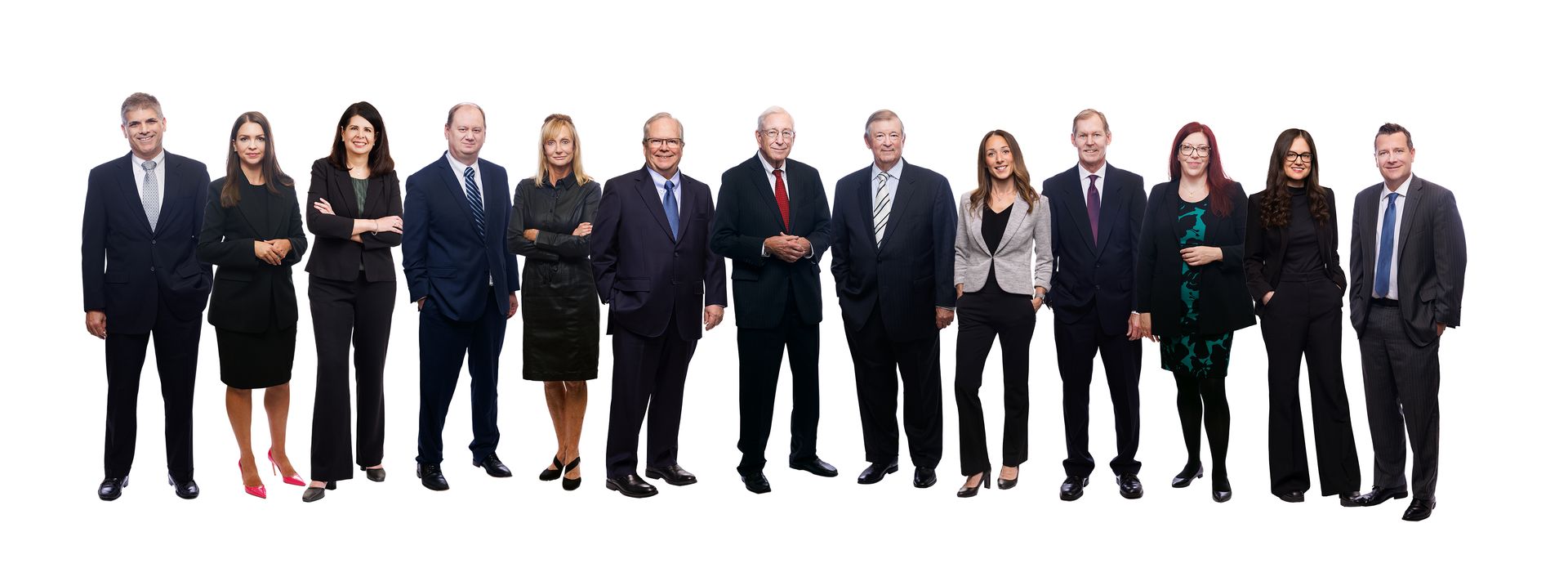 A group of people in suits and ties are standing in a line.