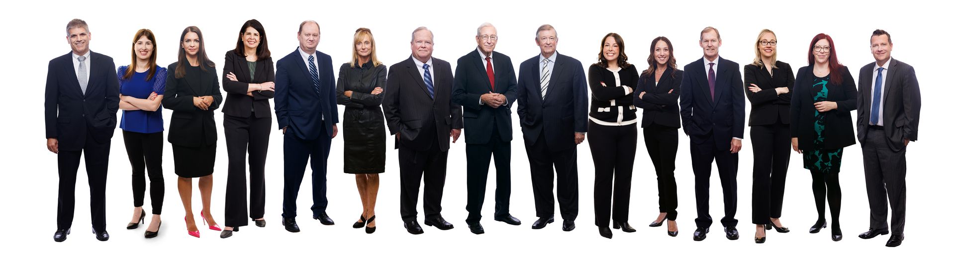 A group of people in suits and ties are standing in a line.