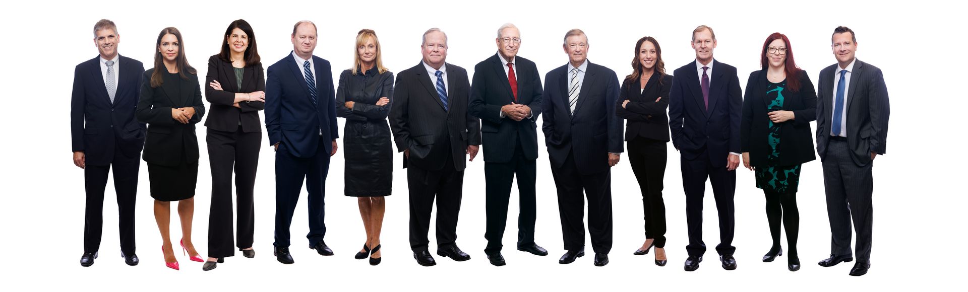 A group of people in suits and ties are standing in a line.