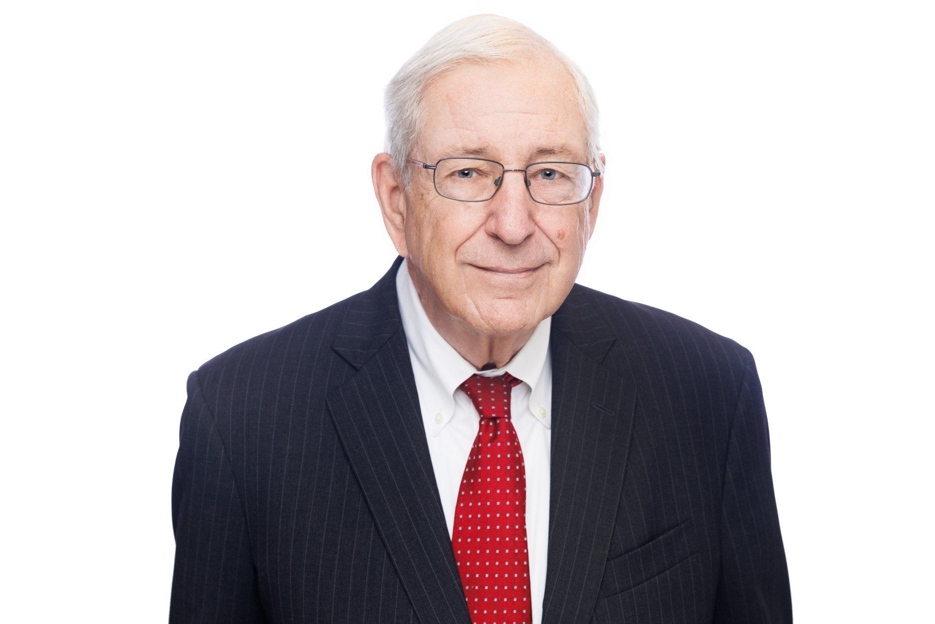 A man in a suit and tie is smiling for the camera.