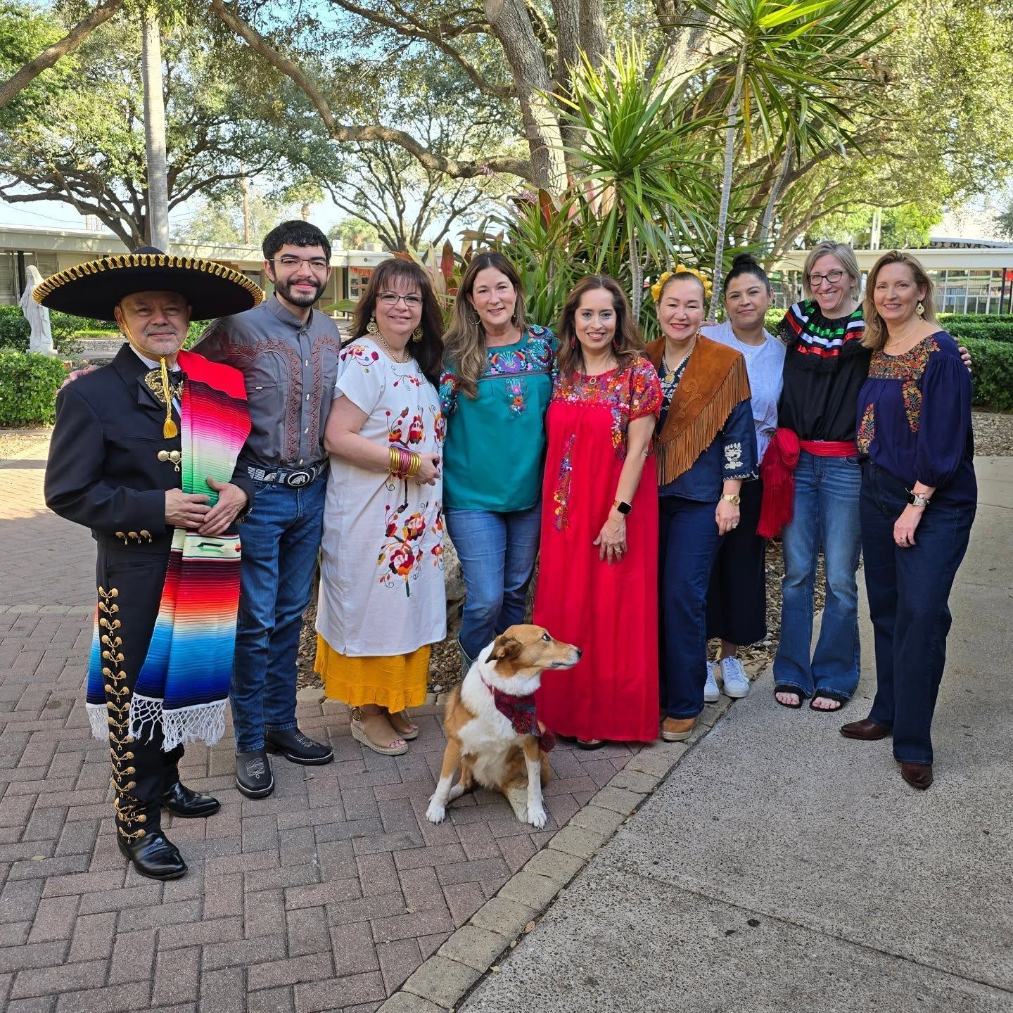 A group of people wearing red shirts are standing in a circle
