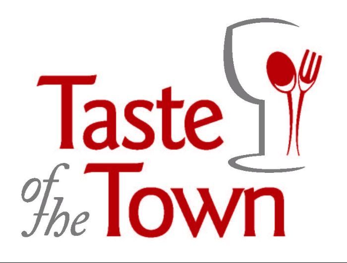 A logo for taste of the town with a fork and spoon
