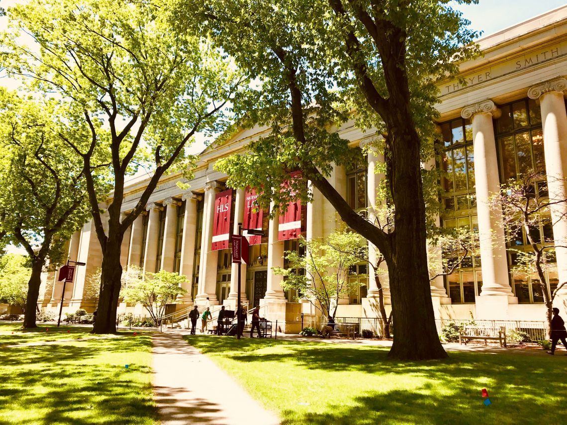 A large building with columns and trees in front of it