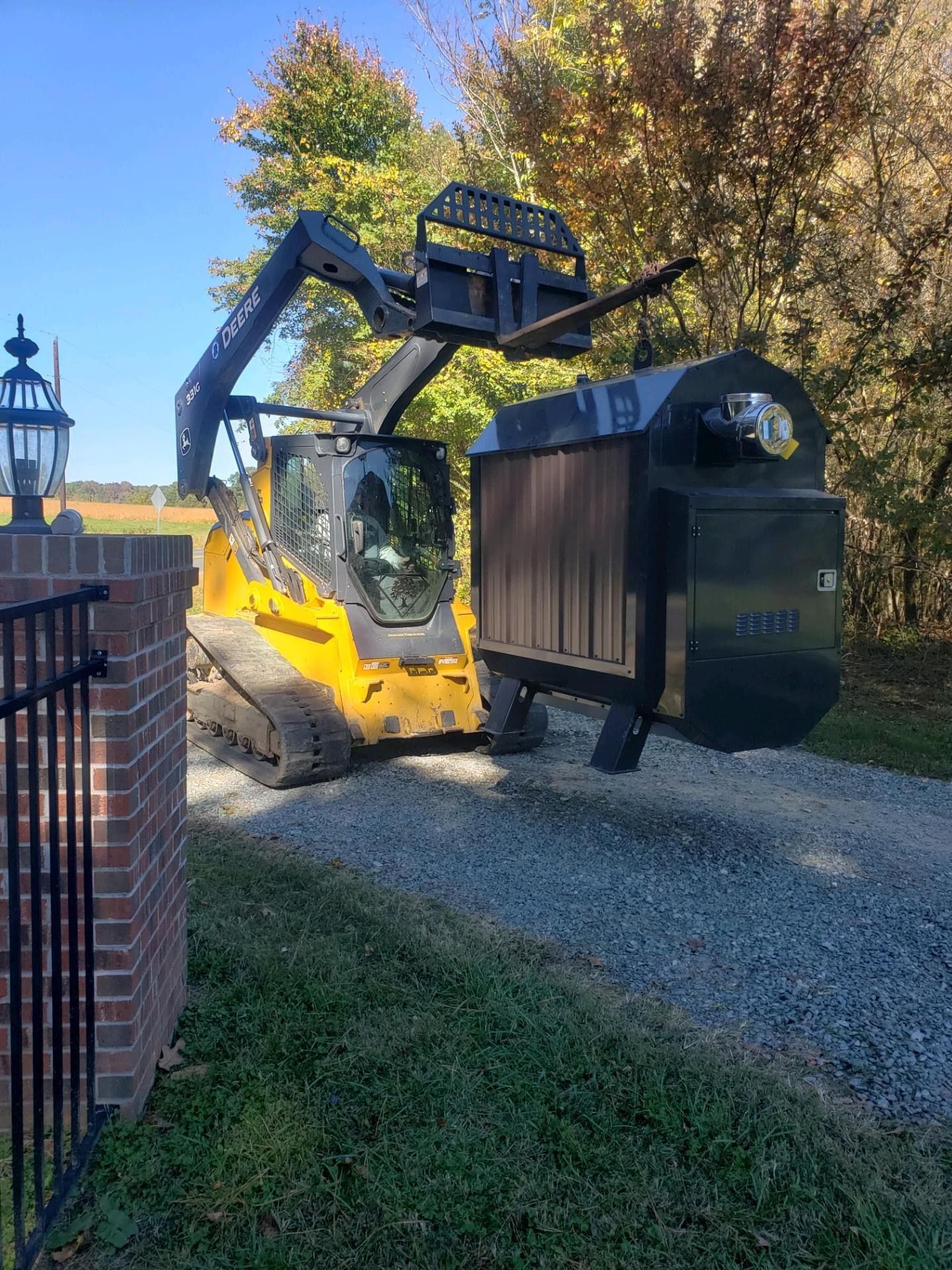 Skid Steer unloading a unit ready for delivery
