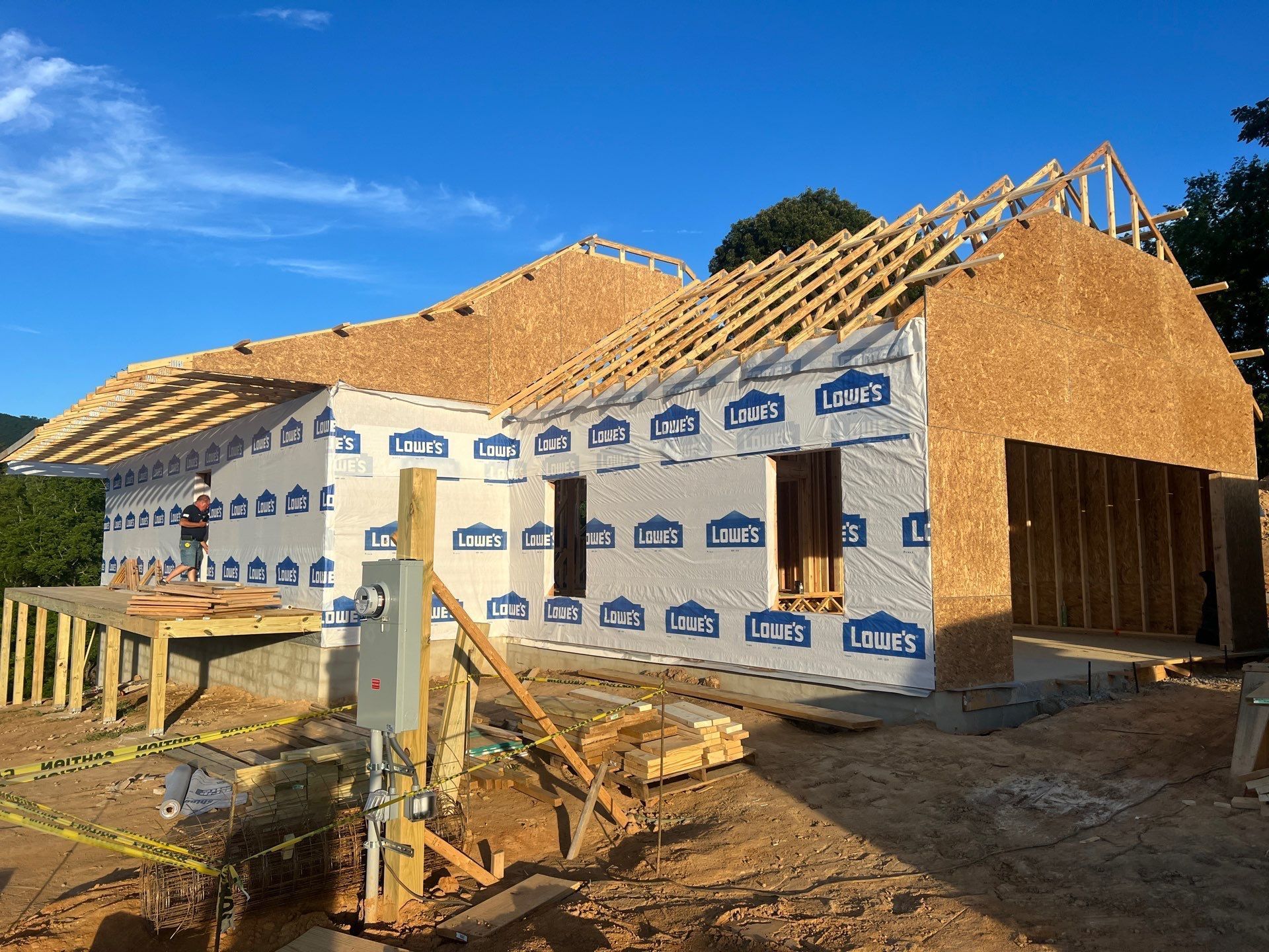 A house is being built in the middle of a dirt field.