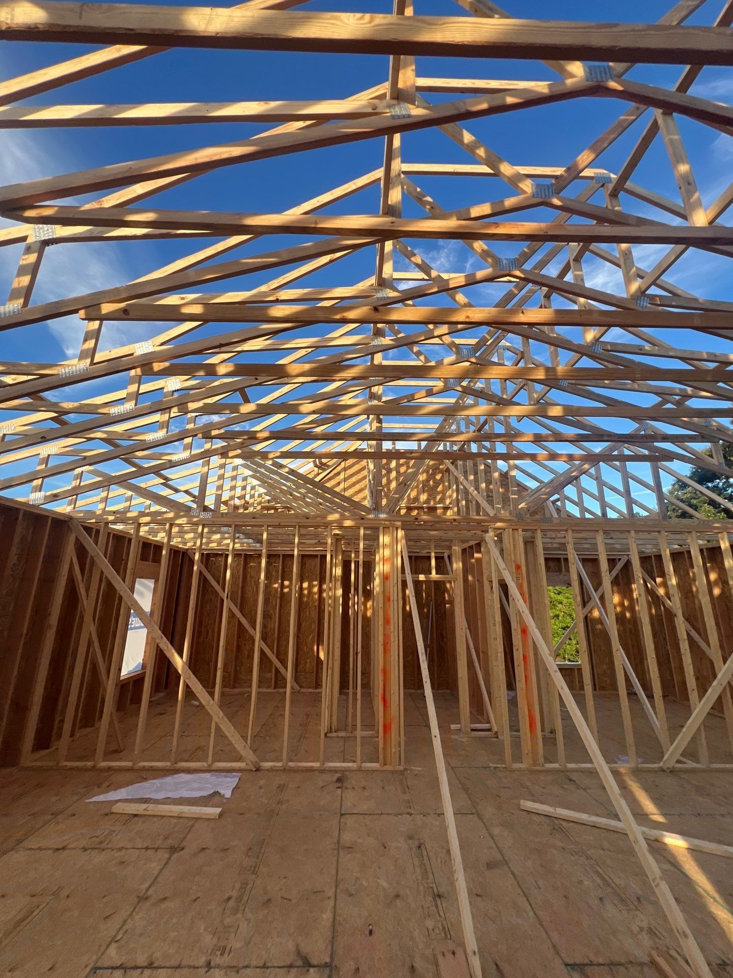 The inside of a house under construction with a blue sky in the background.