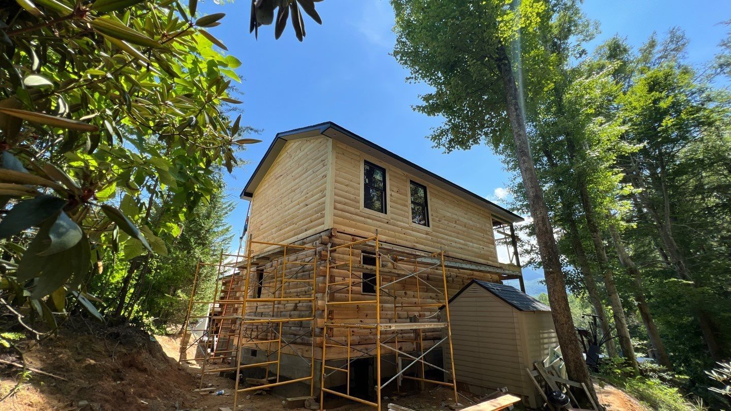 A house is being built on a hill with scaffolding around it.