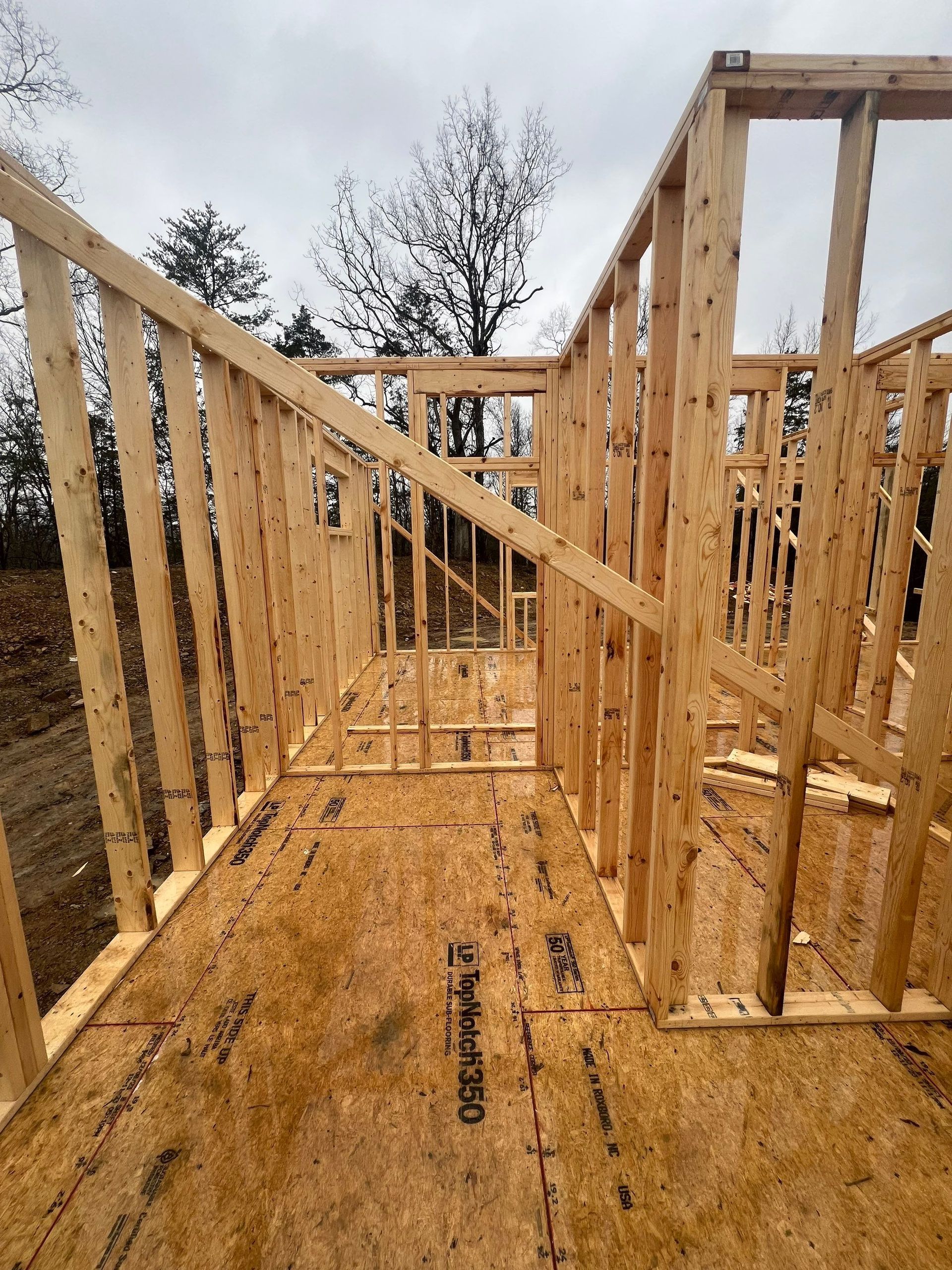 A house is being built with wooden frames and plywood.