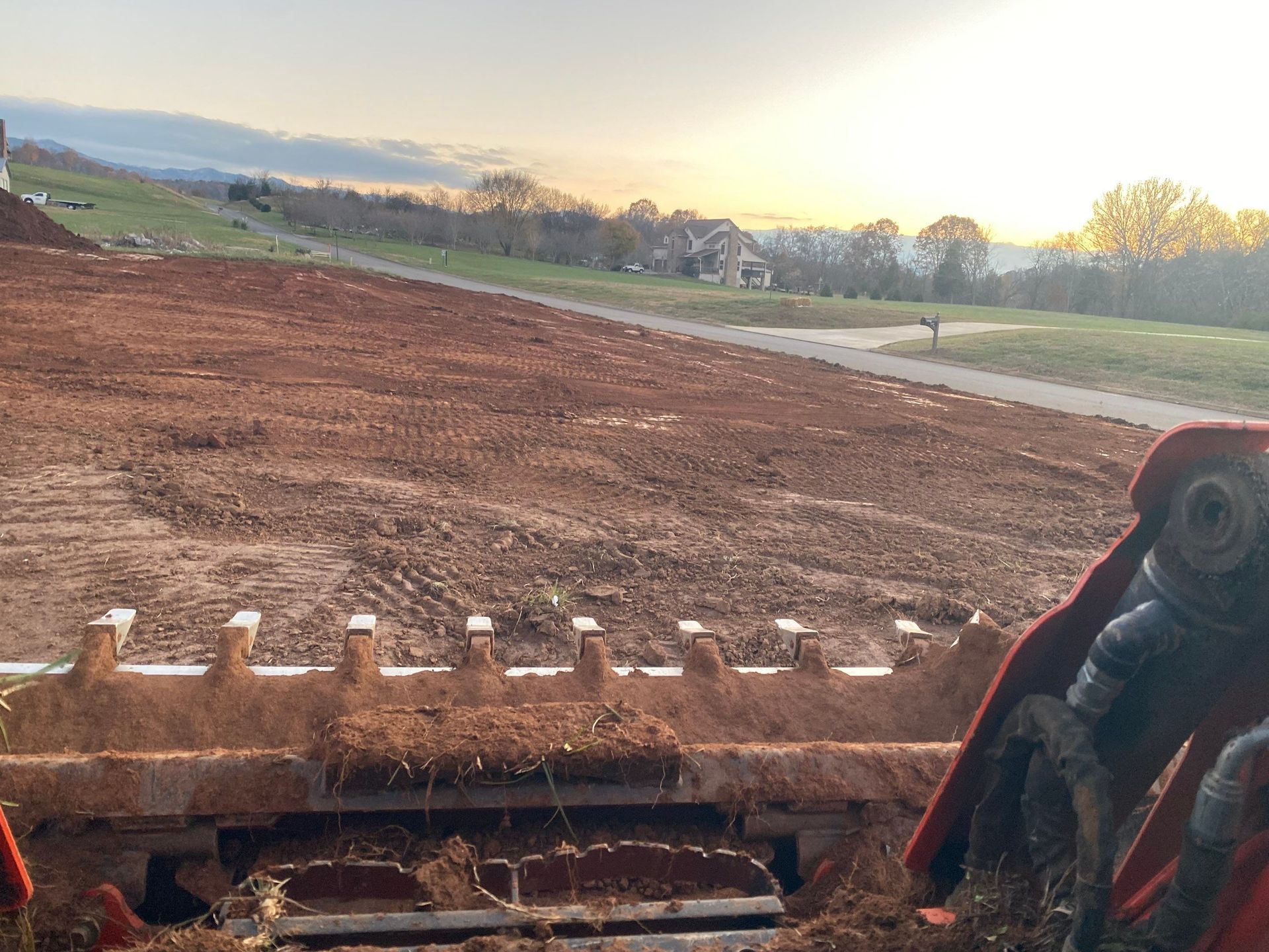 A bulldozer is sitting on top of a dirt field.