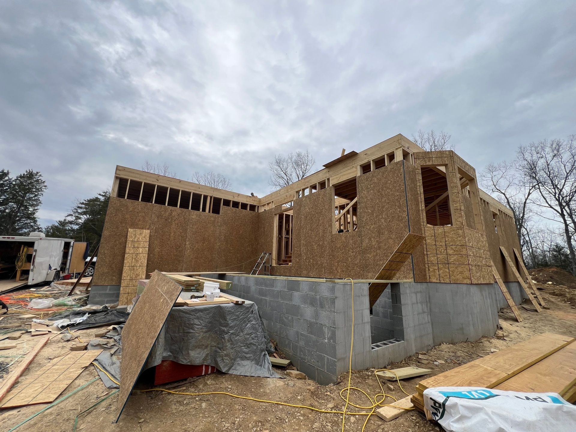 A house is being built in the middle of a dirt field.