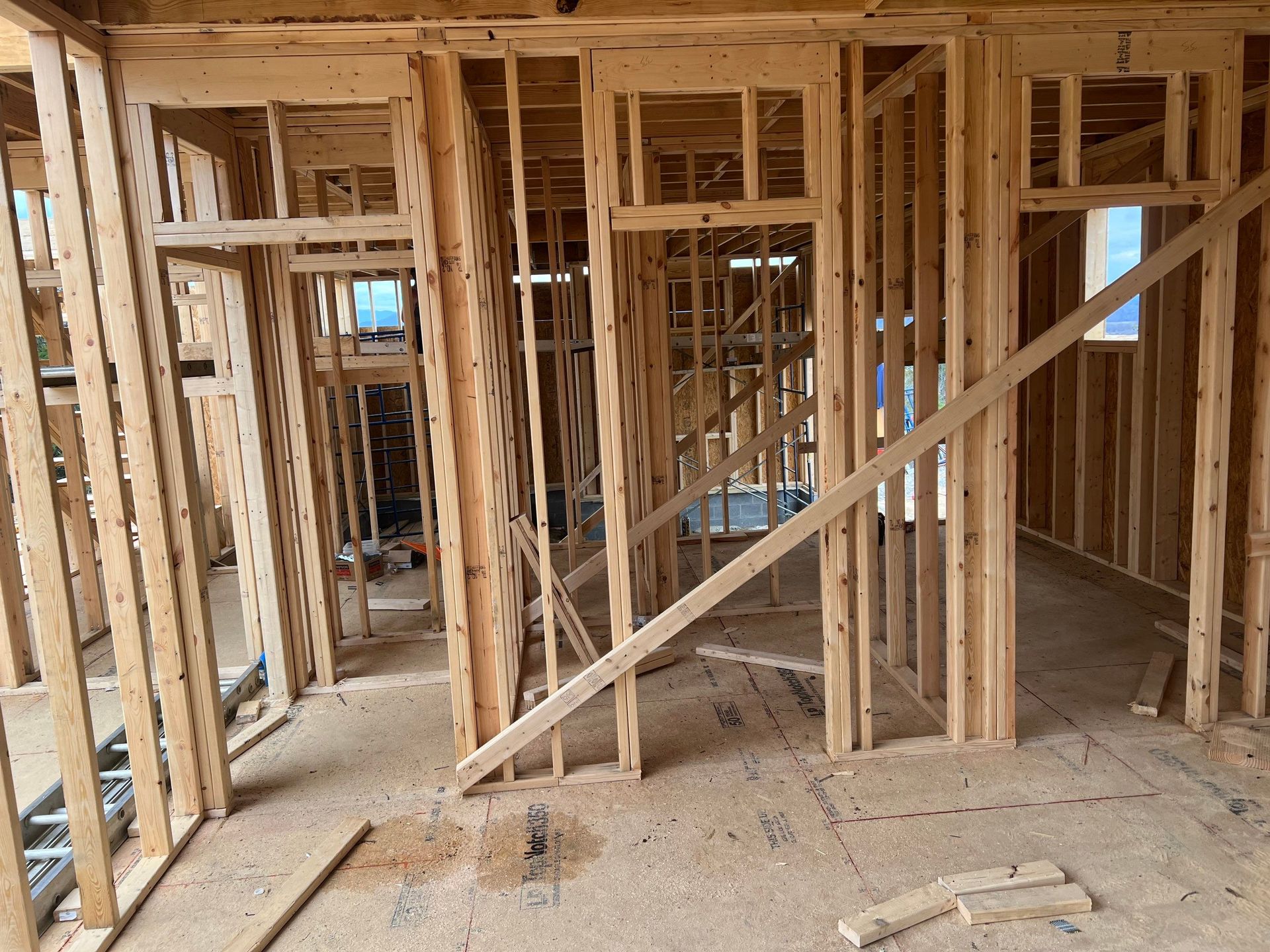 A house is being built with wooden beams and frames.