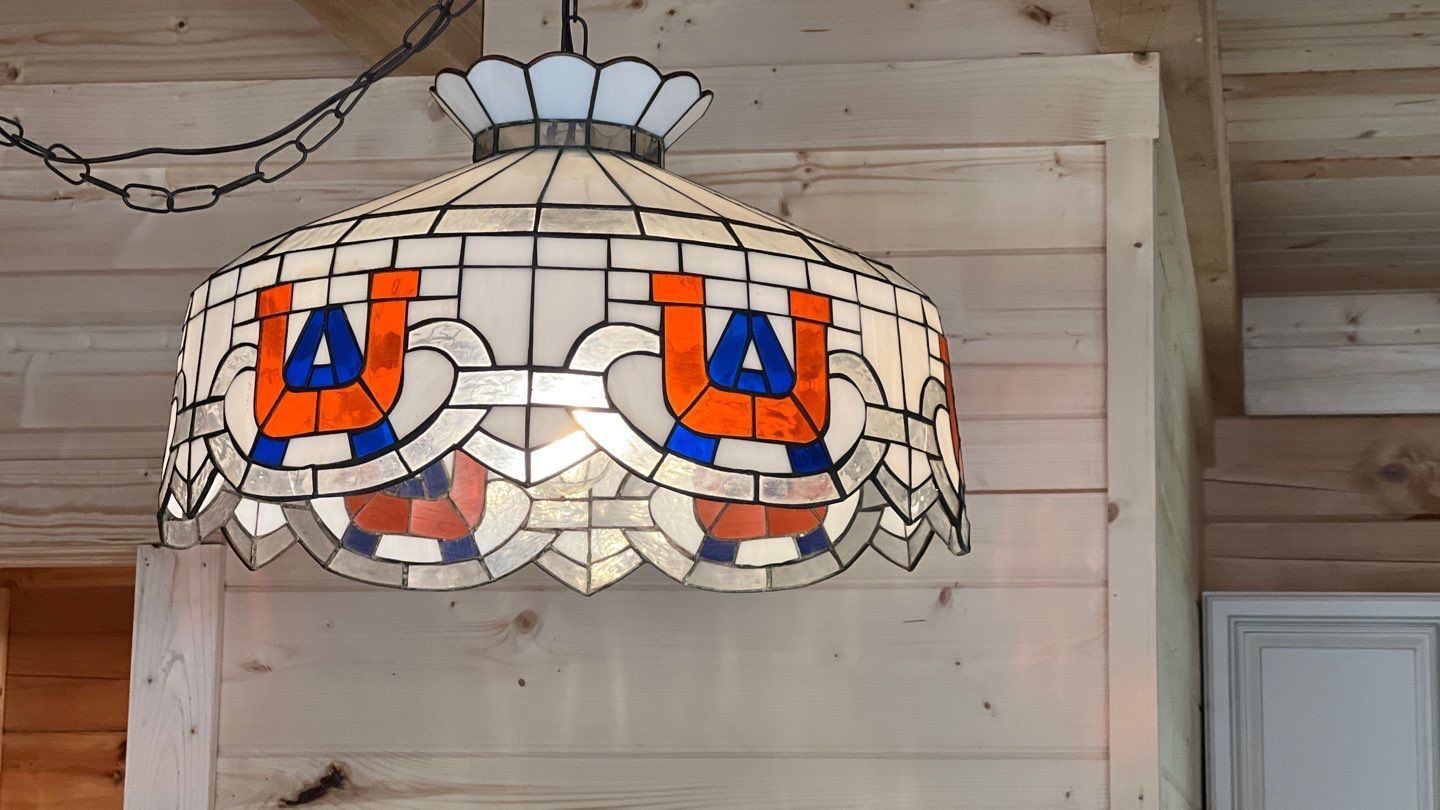 A stained glass lamp with the letter u on it