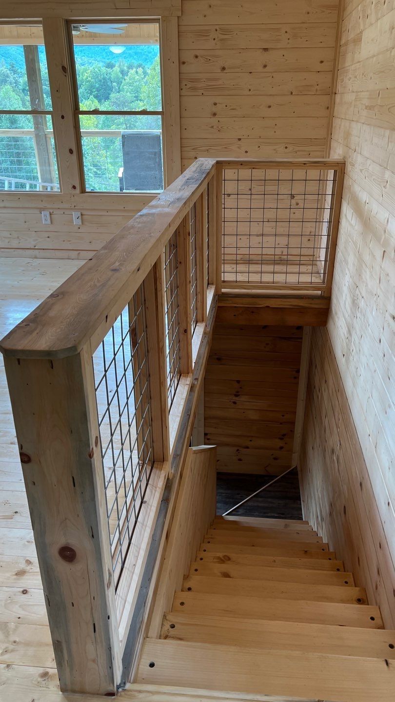 A wooden staircase leading up to the second floor of a house.