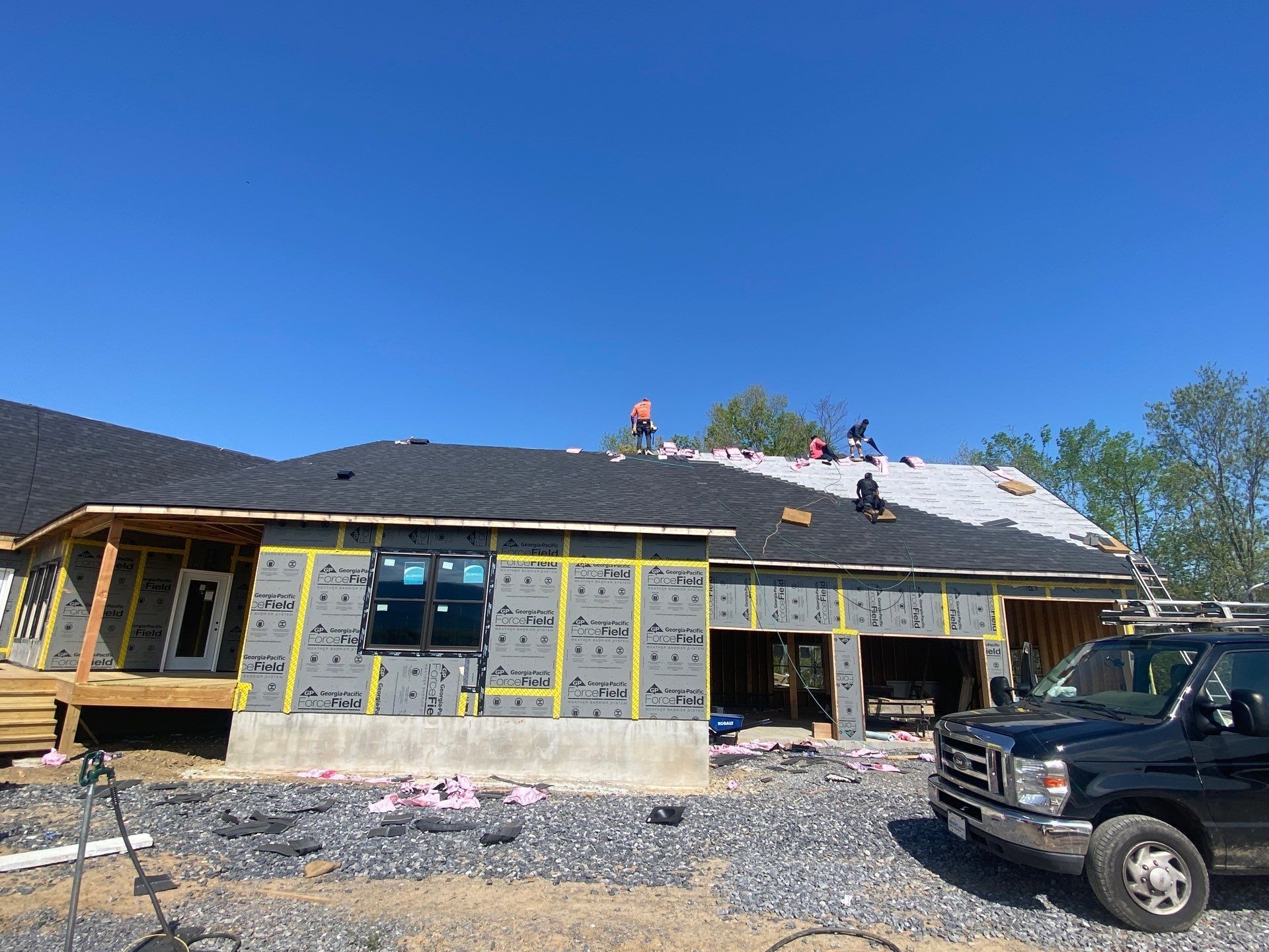 A truck is parked in front of a house under construction.