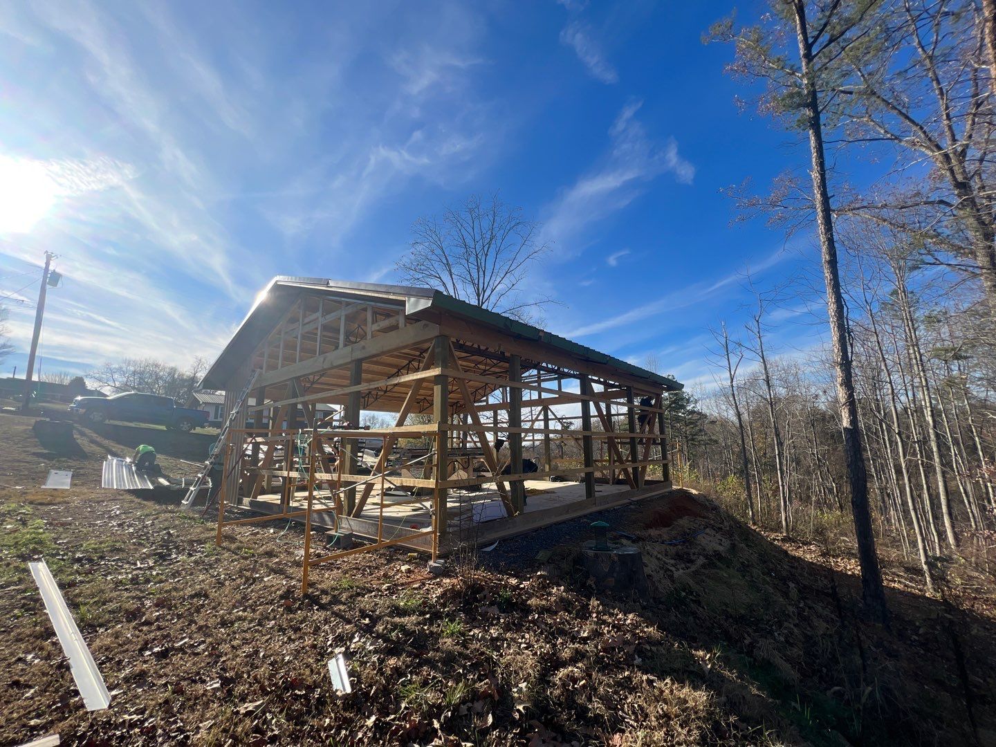 A wooden structure is being built in the middle of a forest.