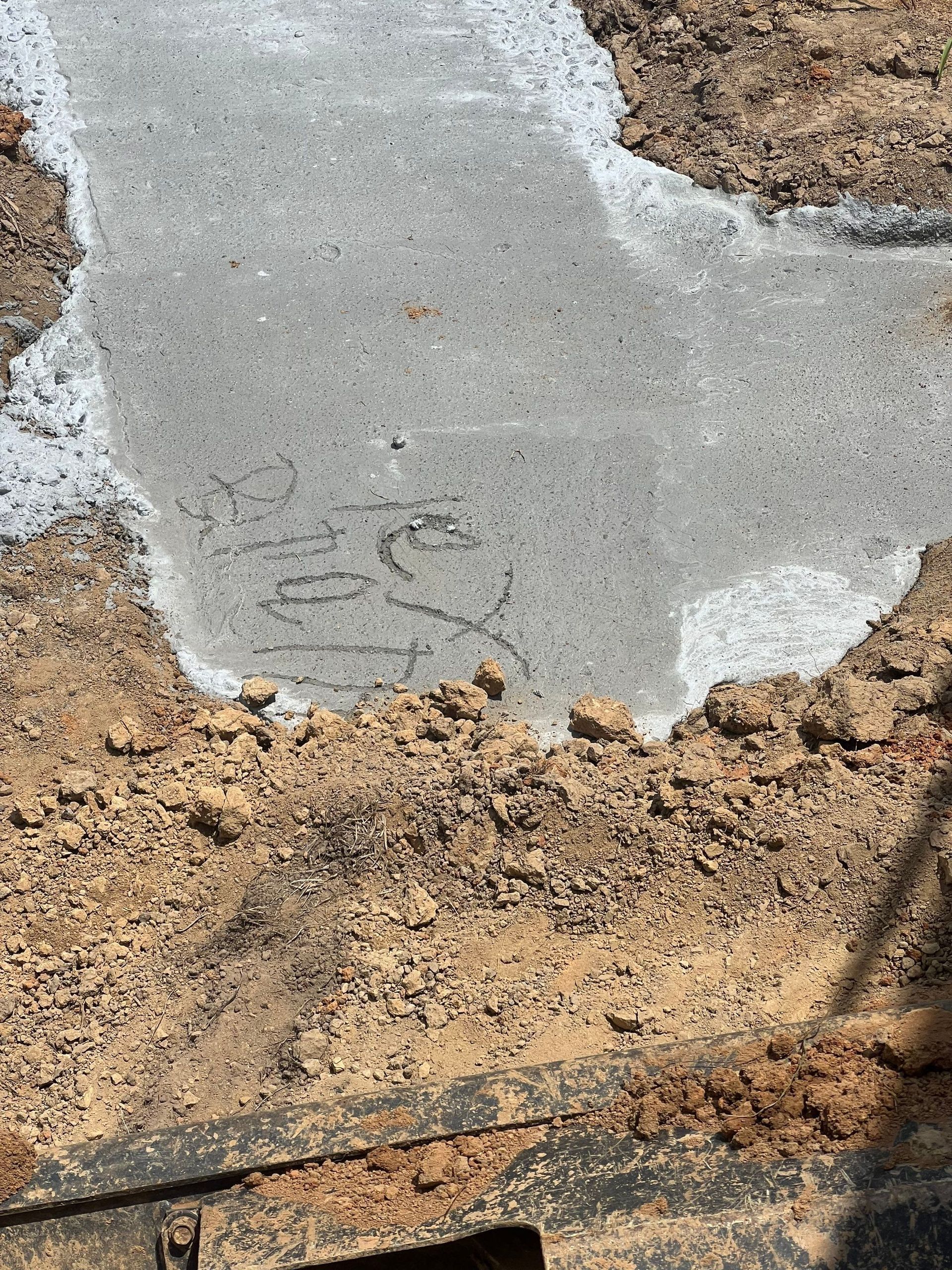 The word yes is written on a piece of concrete
