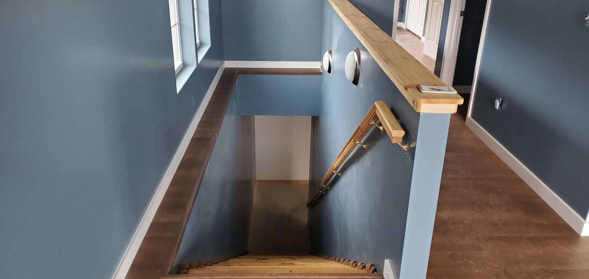 A hallway with stairs leading up to the second floor