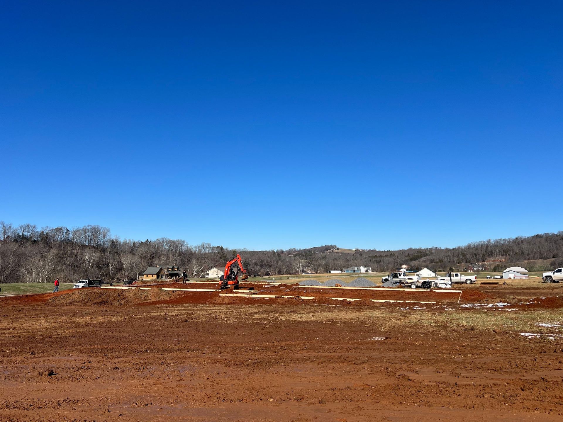 A large dirt field with a blue sky in the background.