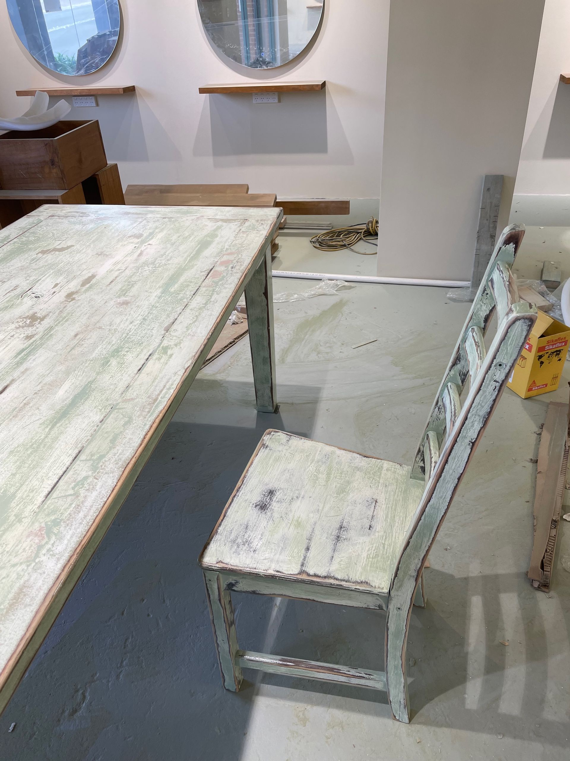 A chair is sitting next to a table in a room