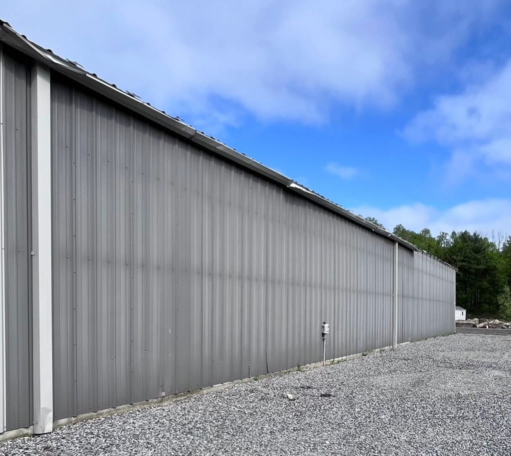 A large gray building with a blue sky in the background