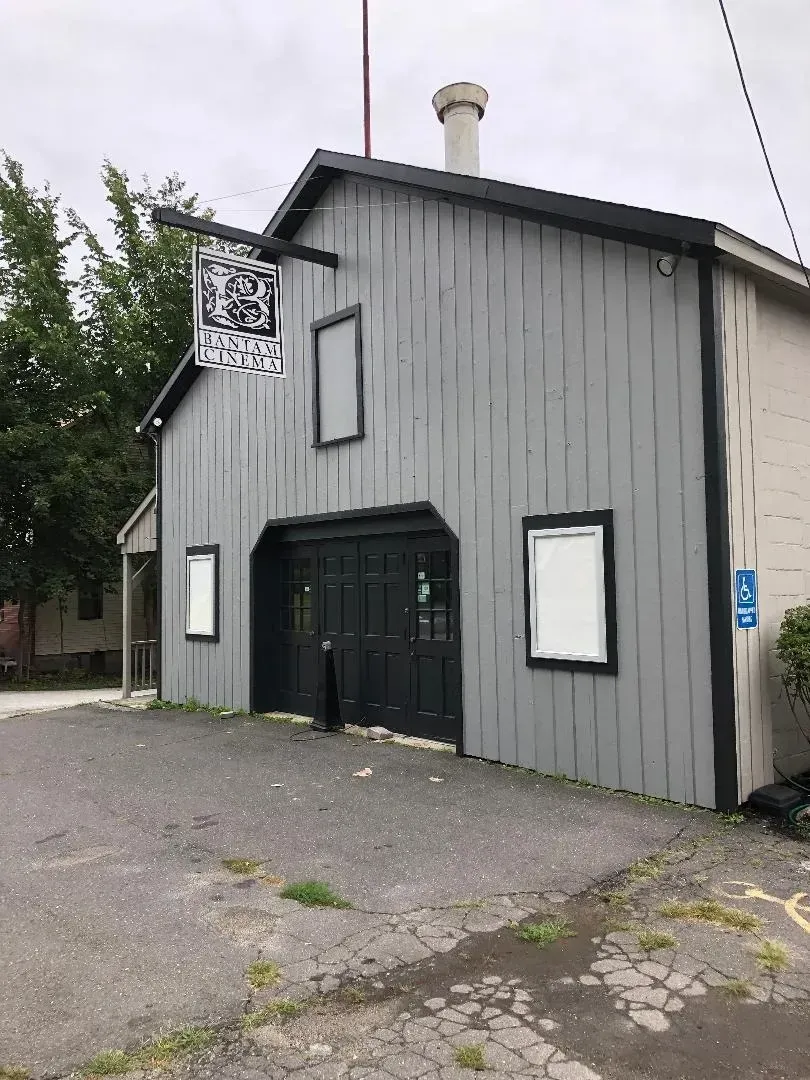 A gray building with a sign on the side that says ' a ' on it.