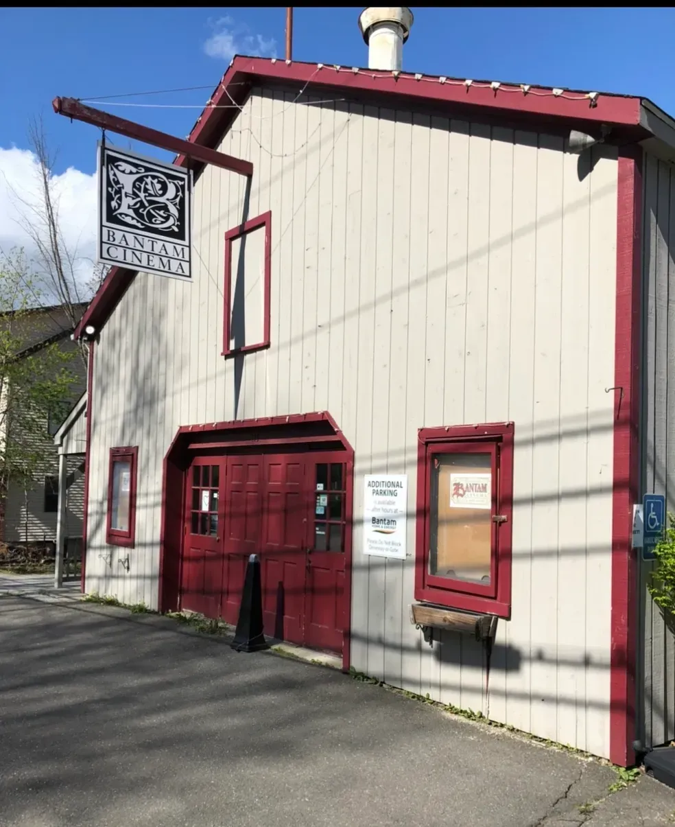 A building with a red garage door and a sign that says ' a ' on it