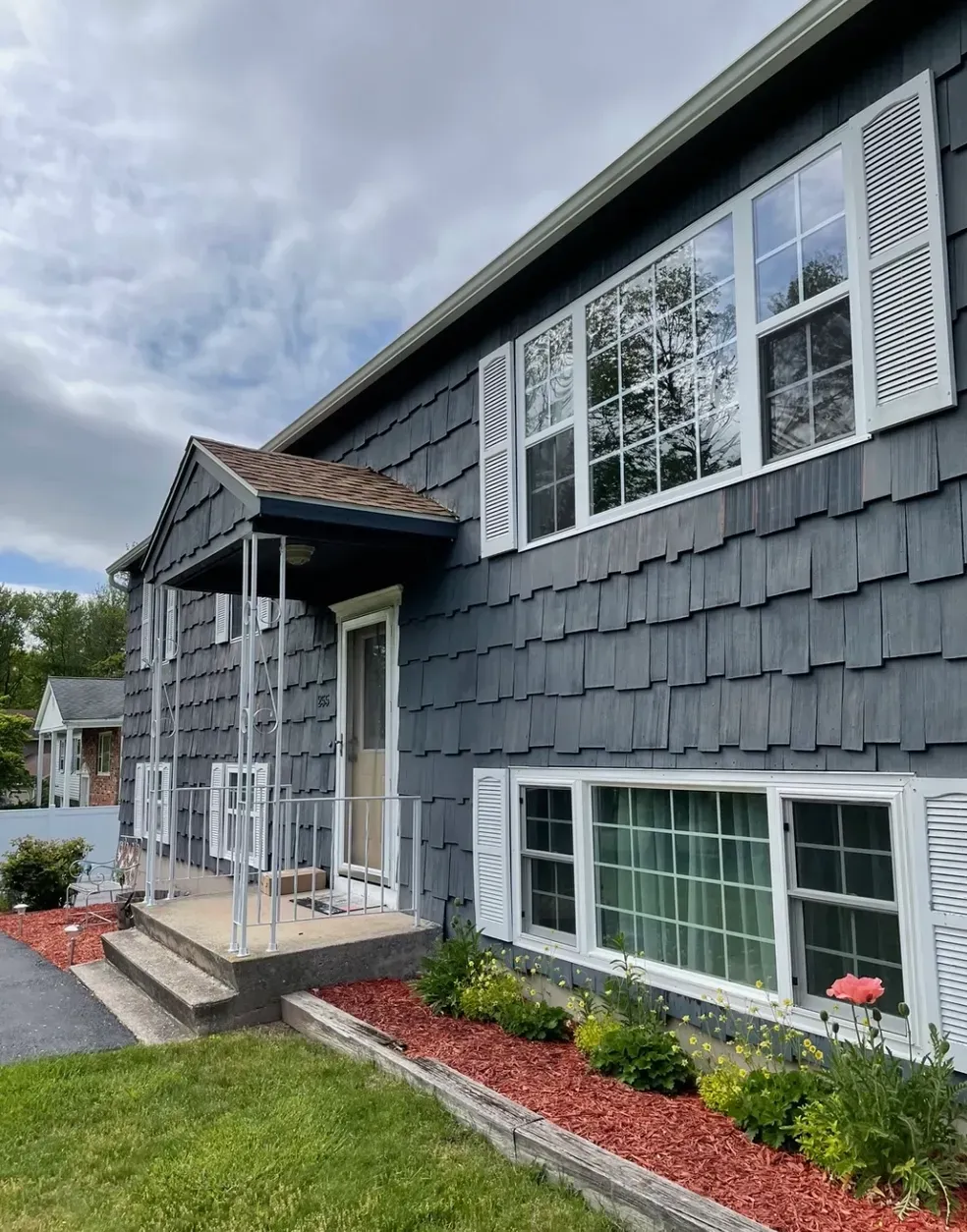 A large house with a lot of windows and a porch.