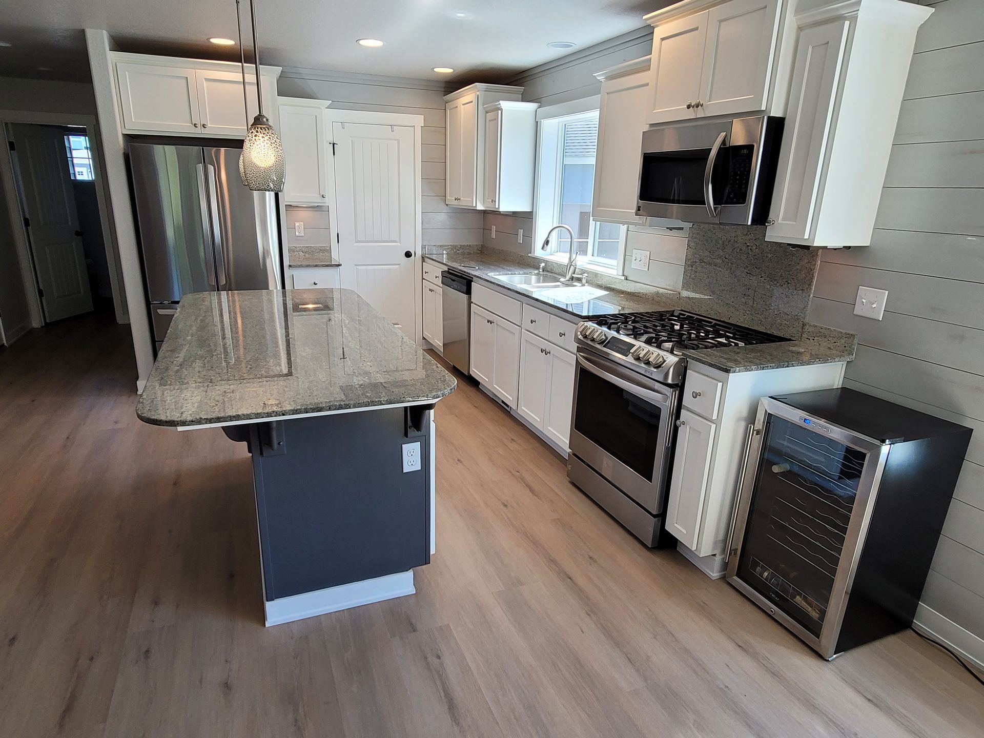 A kitchen with stainless steel appliances and granite counter tops.
