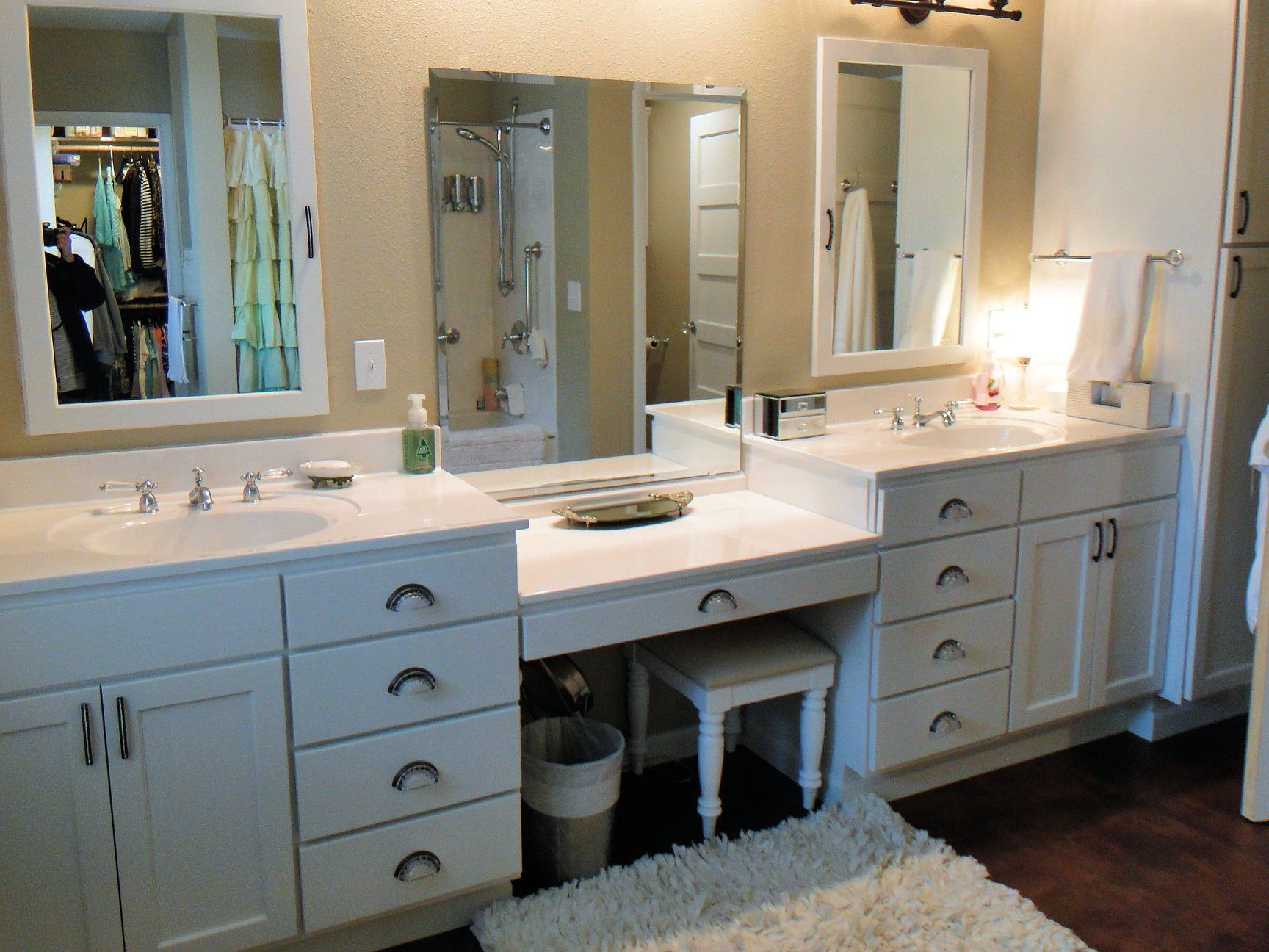 A bathroom with two sinks and two mirrors