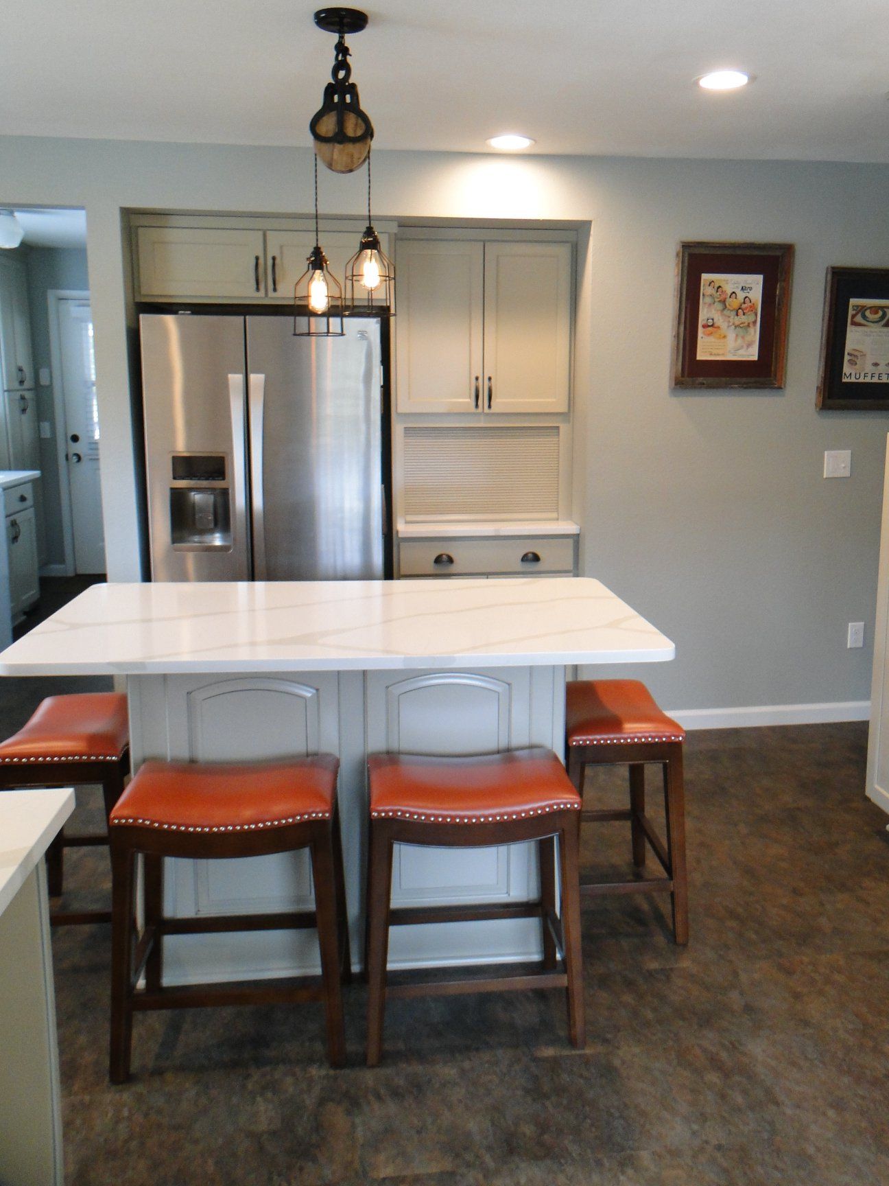 A kitchen with a large island and stools