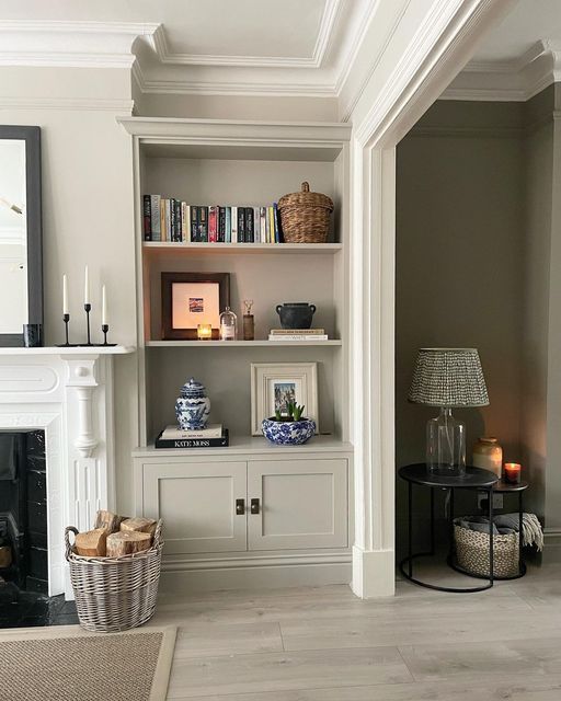 A living room with a fireplace and a bookshelf
