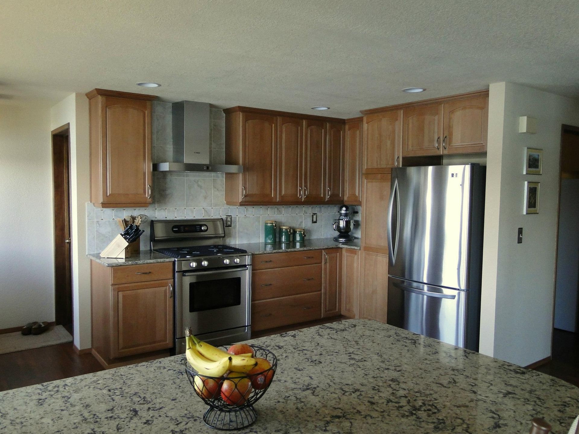 A kitchen with stainless steel appliances and wooden cabinets