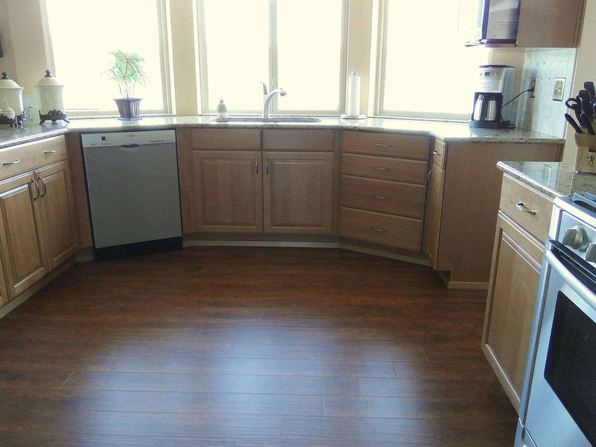 A kitchen with wooden cabinets and granite counter tops