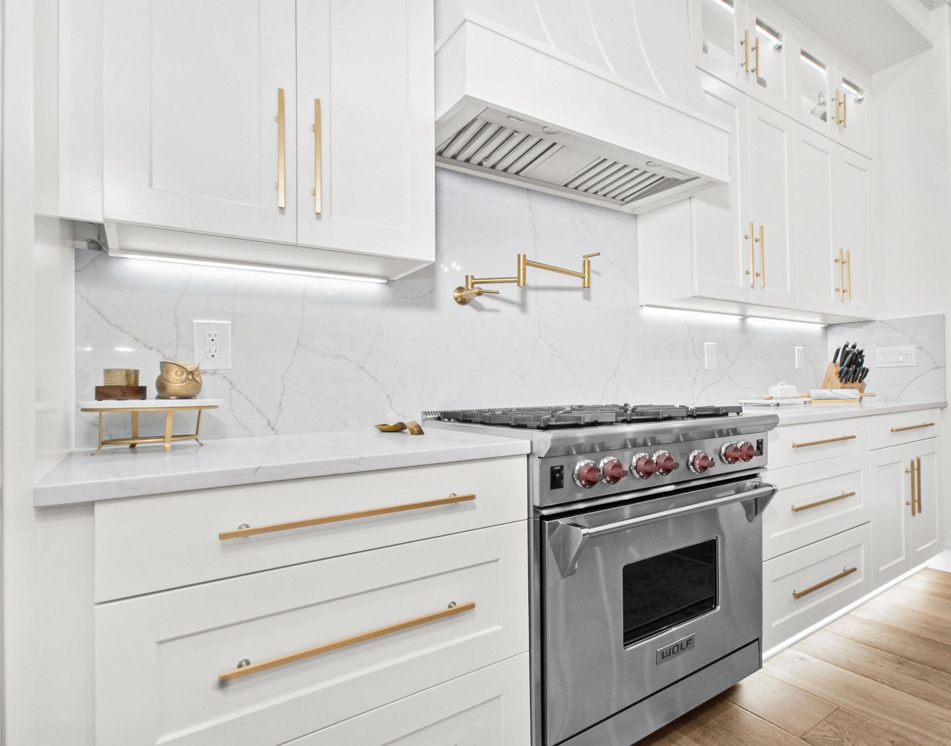 A kitchen with white cabinets and stainless steel appliances.