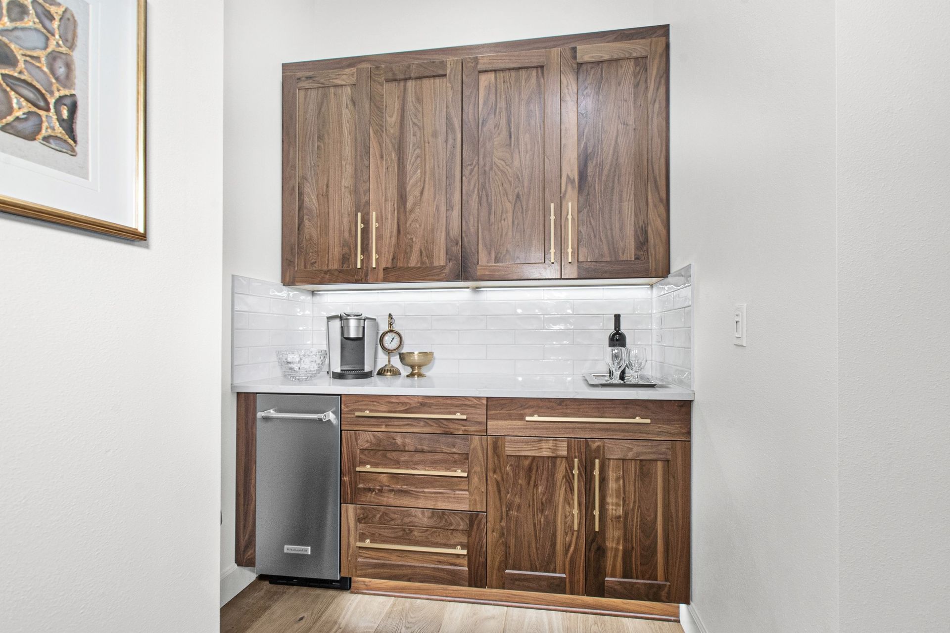 A kitchen with wooden cabinets and a stainless steel dishwasher.