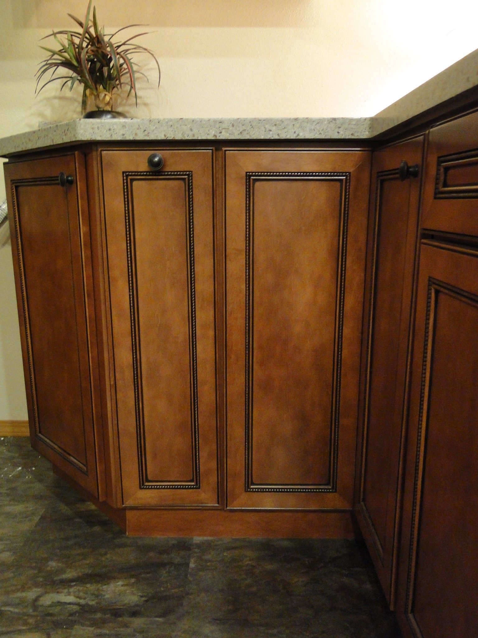 A kitchen with wooden cabinets and a granite counter top