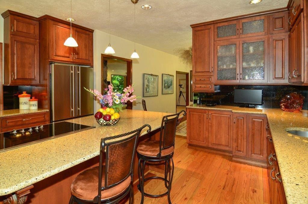 A kitchen with wooden cabinets and granite counter tops