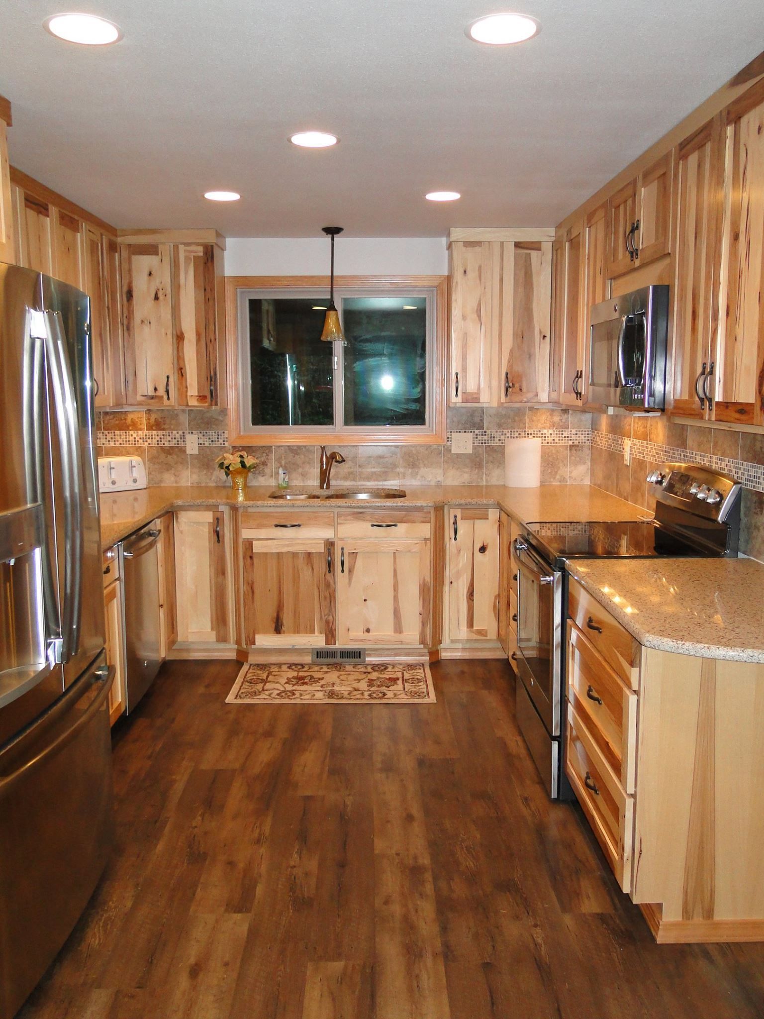 A kitchen with wooden cabinets and stainless steel appliances