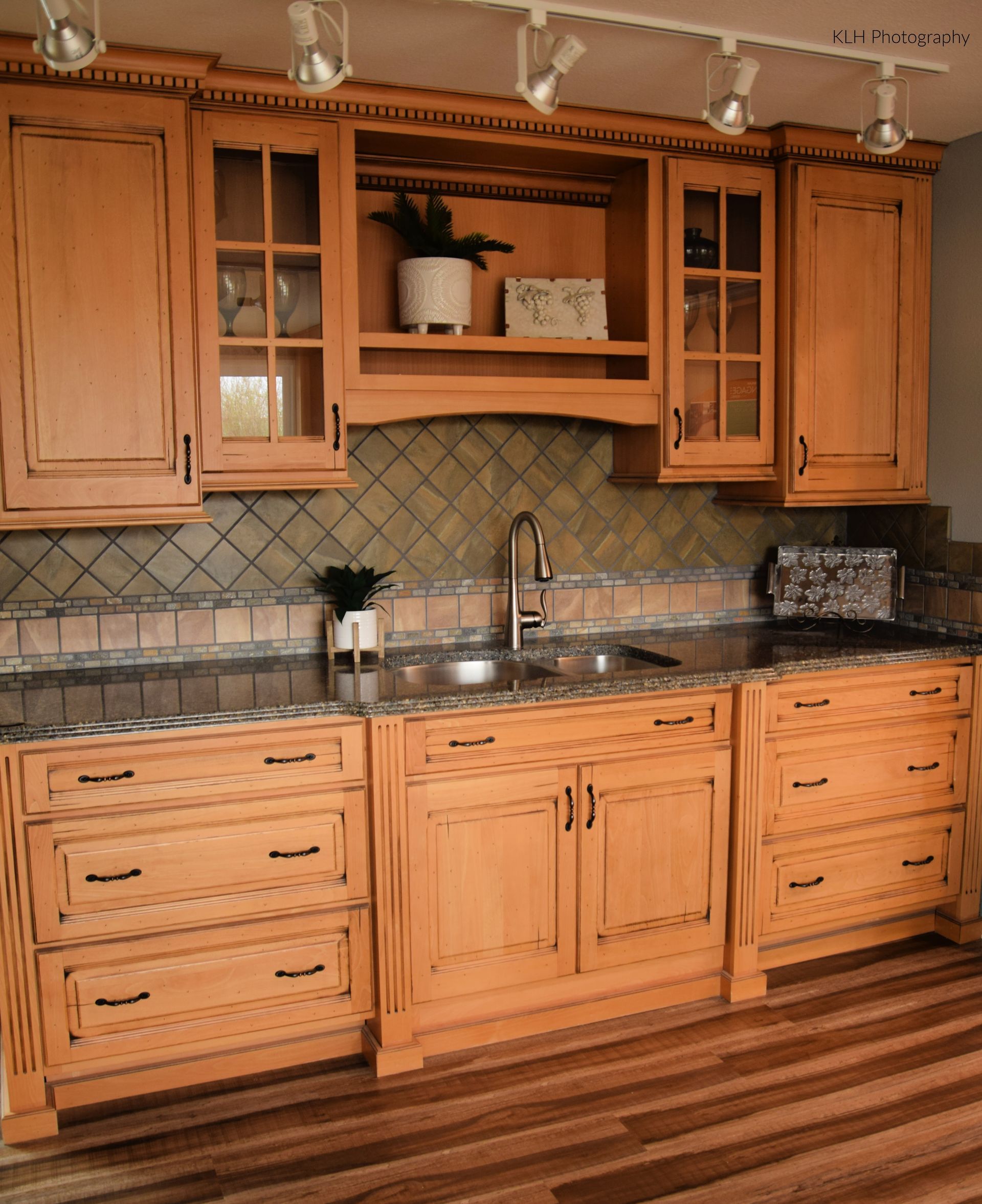 A kitchen with wooden cabinets and granite counter tops