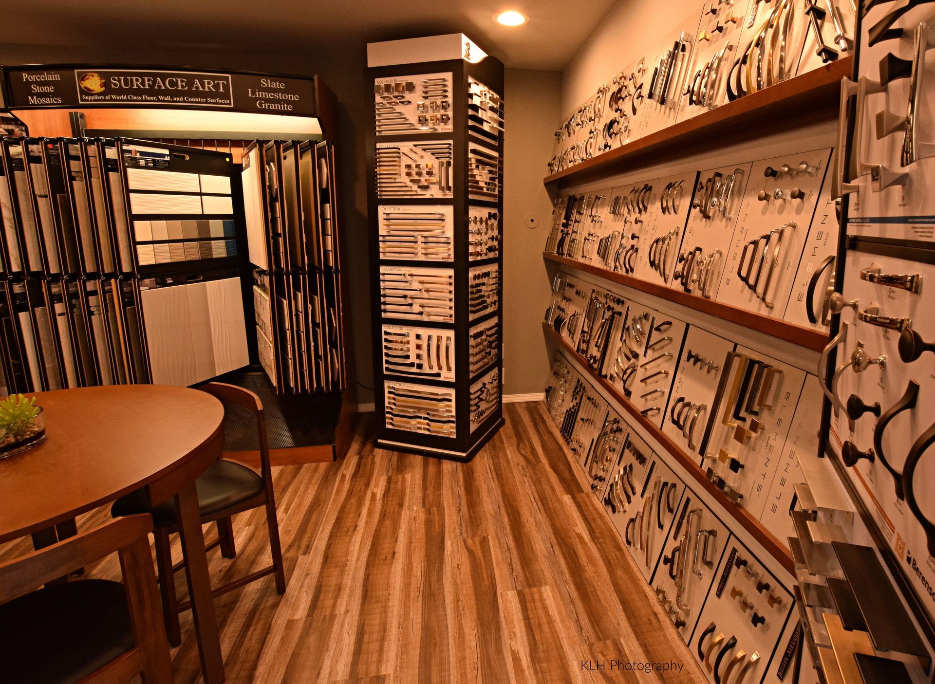 A room with a table and chairs and a display of hardware.