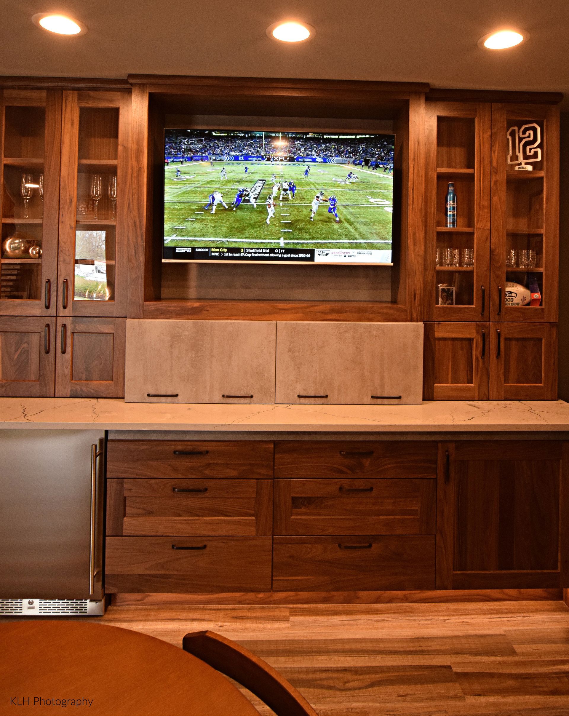 A kitchen with a large flat screen tv on the wall